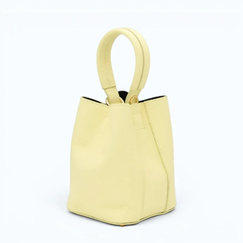 Flow butter yellow leather handbag  closed side 2