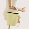 Flow butter yellow leather handbag on hand