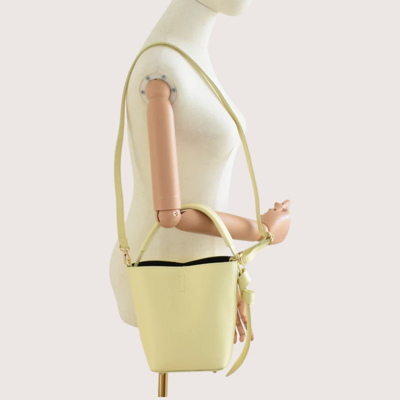 Flow butter yellow leather handbag on shoulder