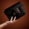 horsy black crossbody leather bag on hand