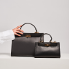 sophia black leather handbag on hand