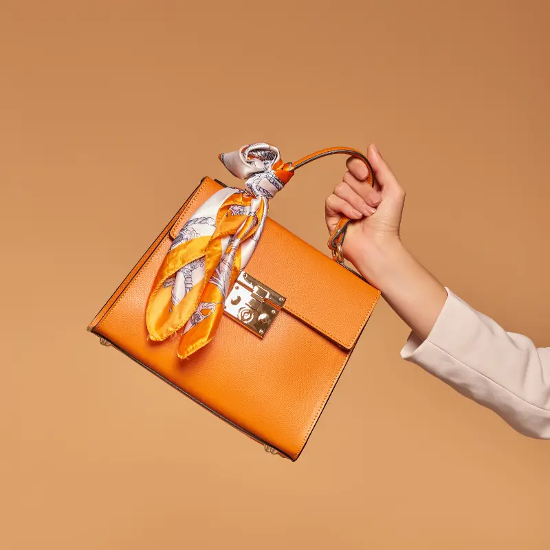 diva orange leather handbag on model