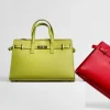 carine green leather handbag on set