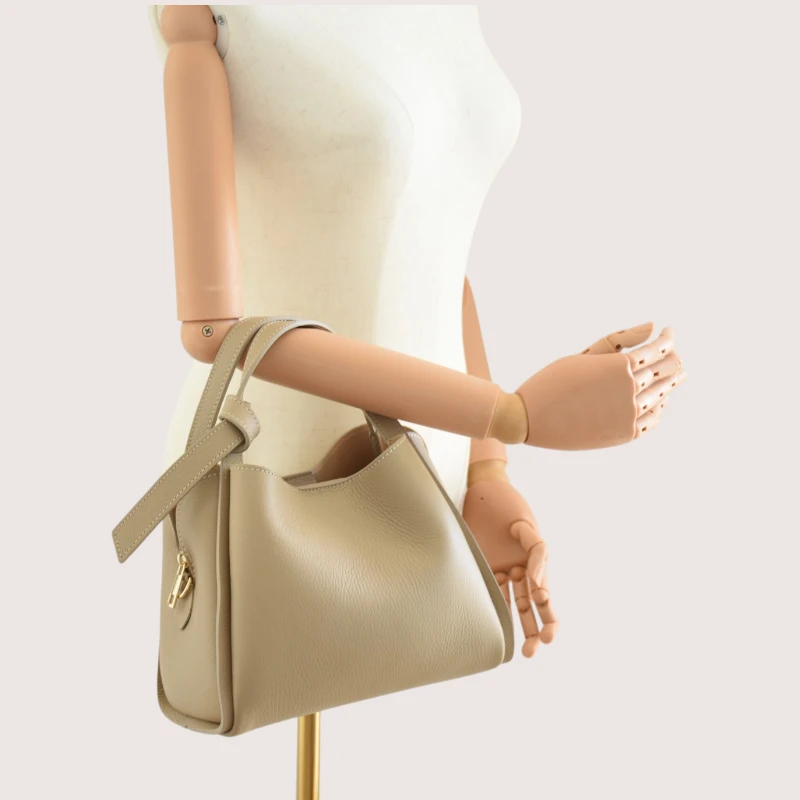 bruna taupe leather handbag on hand