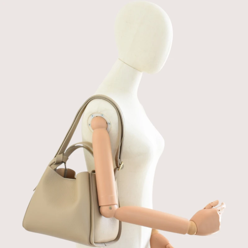 bruna taupe leather handbag on shoulder
