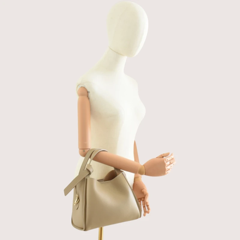 bruna taupe leather handbag on shoulder