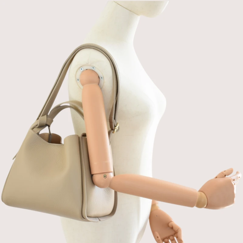 bruna taupe leather handbag on shoulder
