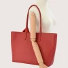 red leather tote bag on model